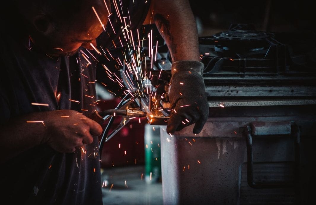 Specialist welder performing TIG welding on metal component